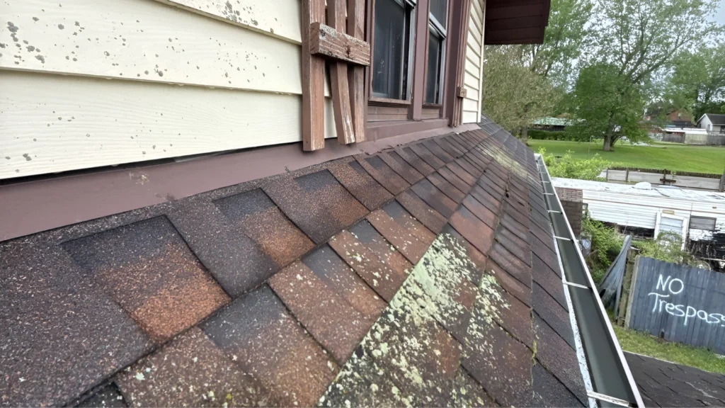 Aging asphalt shingle roof on a Nebraska home before a house sale