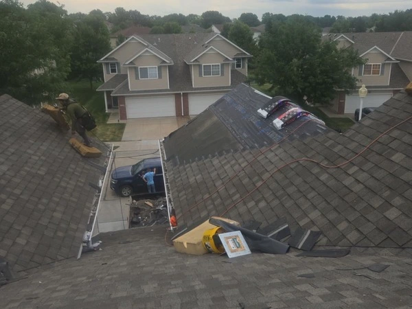 Star Home roofing technician inspecting a storm-damaged roof in Nebraska